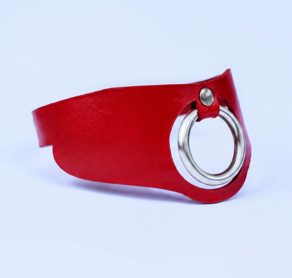A red leather choker necklace with a silver ring on the front.