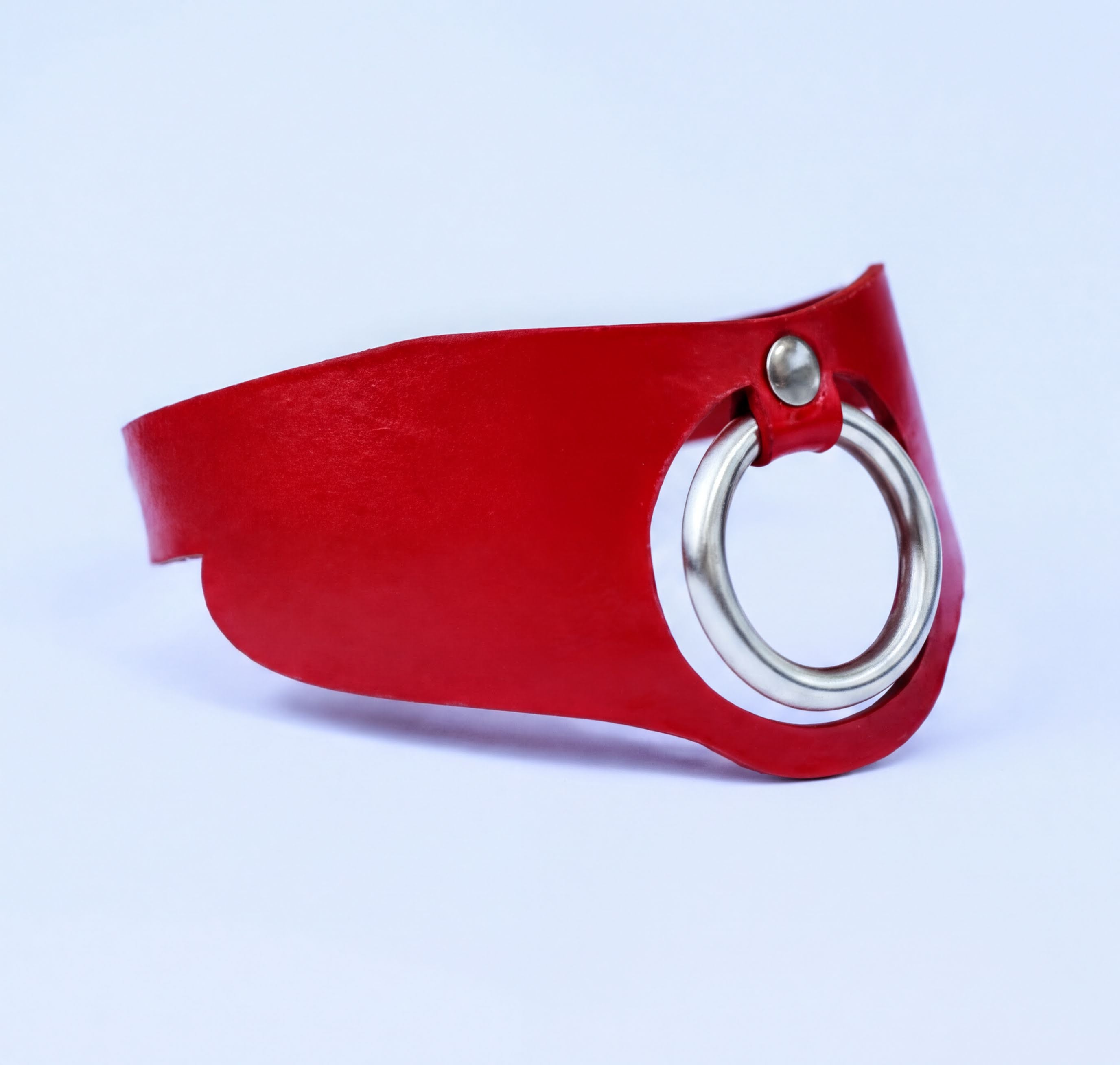 A red leather choker necklace with a silver ring on the front.