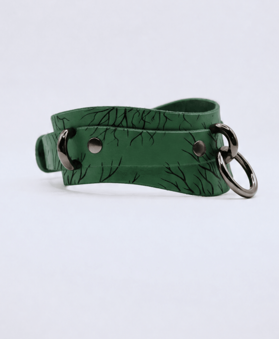 A green leather choker necklace with a metal clasp and a metal ring.