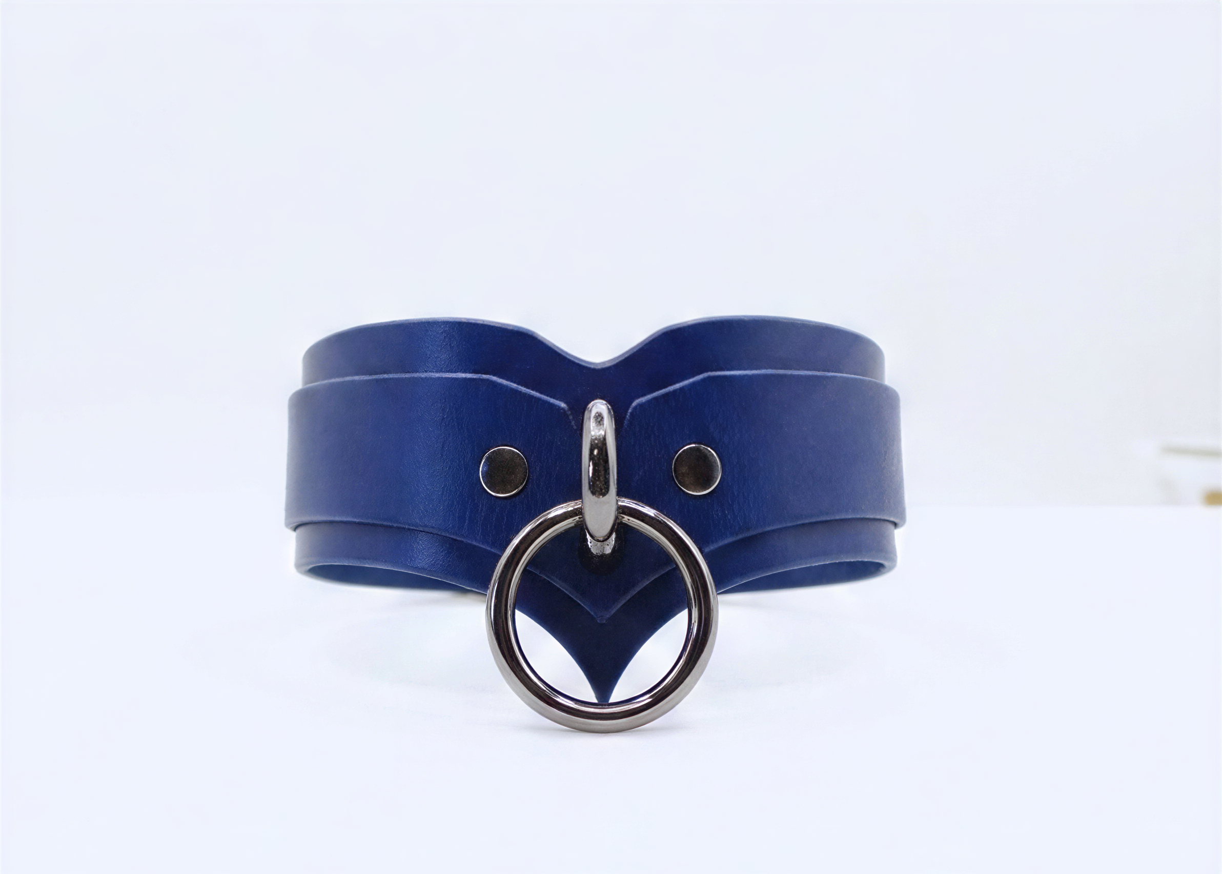 A blue leather choker necklace with a silver metal ring and buckle.