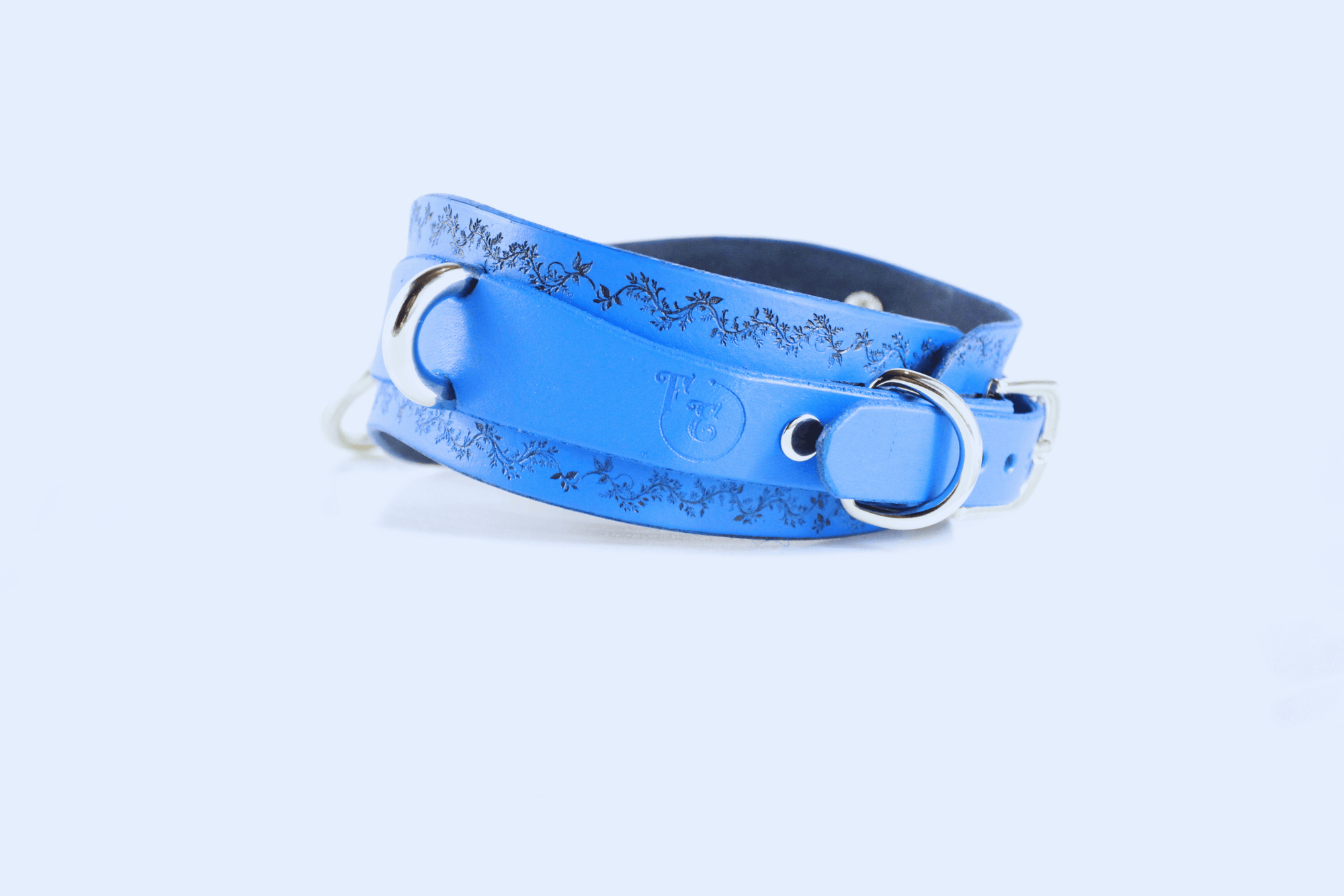 Floral Vine Posture Collar in blue leather with metallic hardware and floral motif design.