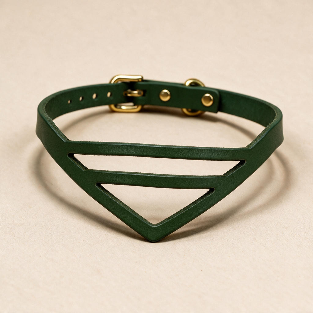 A green leather choker necklace with a geometric design and a gold buckle.