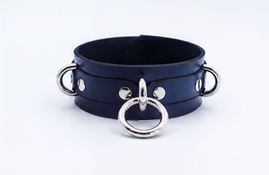 A dark blue leather choker necklace with silver metal rings and buckles.