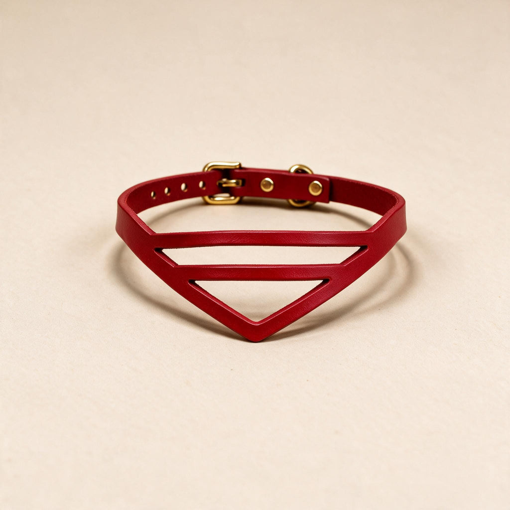 A red leather choker necklace with a unique triangular cutout design.