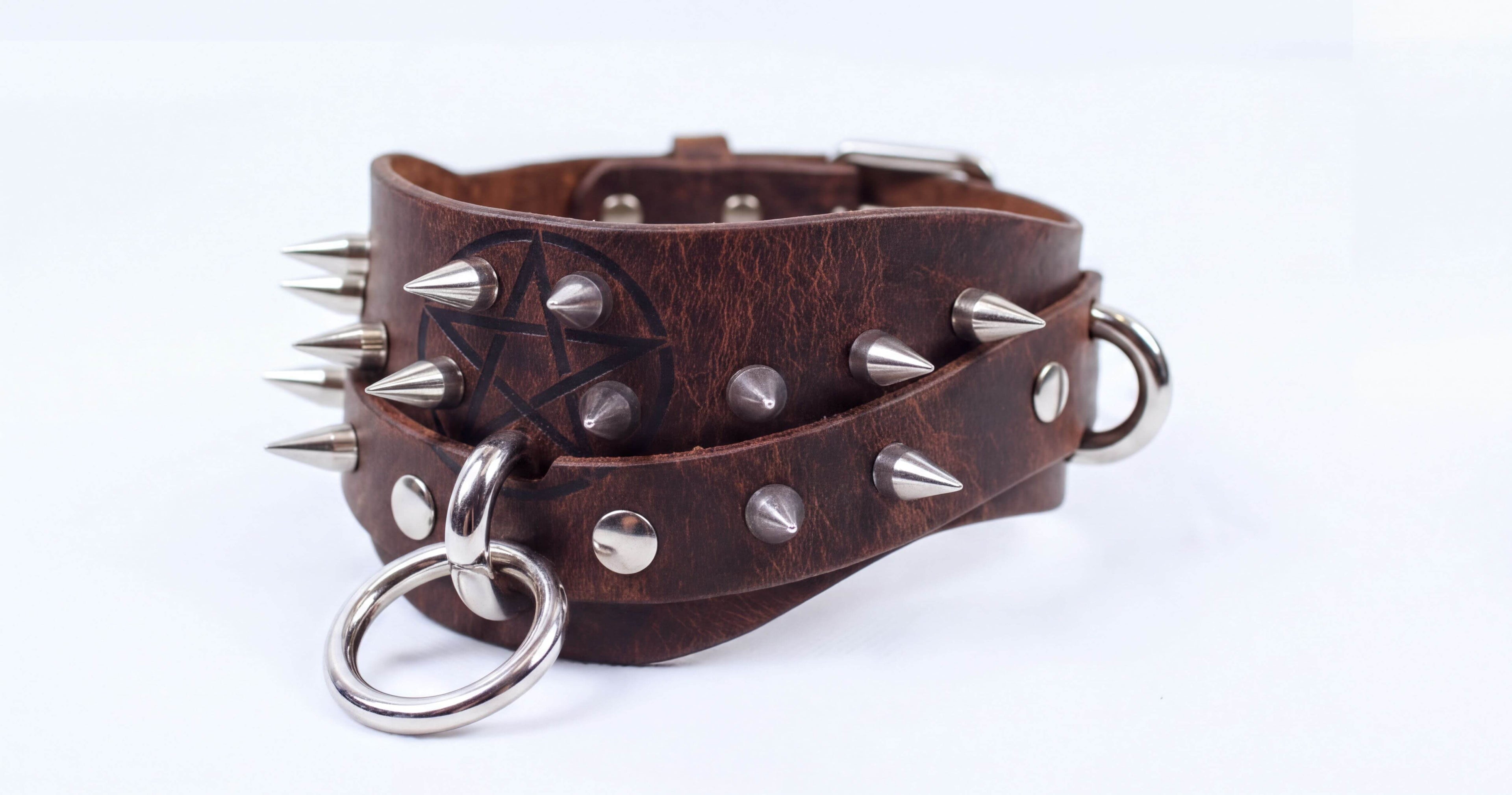 A brown leather choker bracelet with metal spikes and a metal ring.