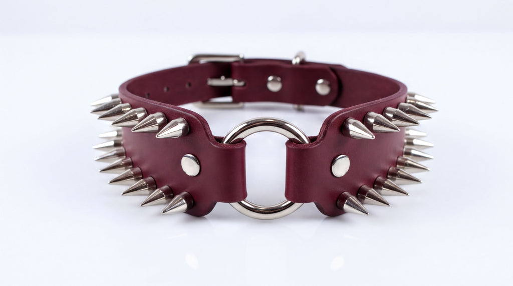 A burgundy leather choker necklace with spikes protruding from it.