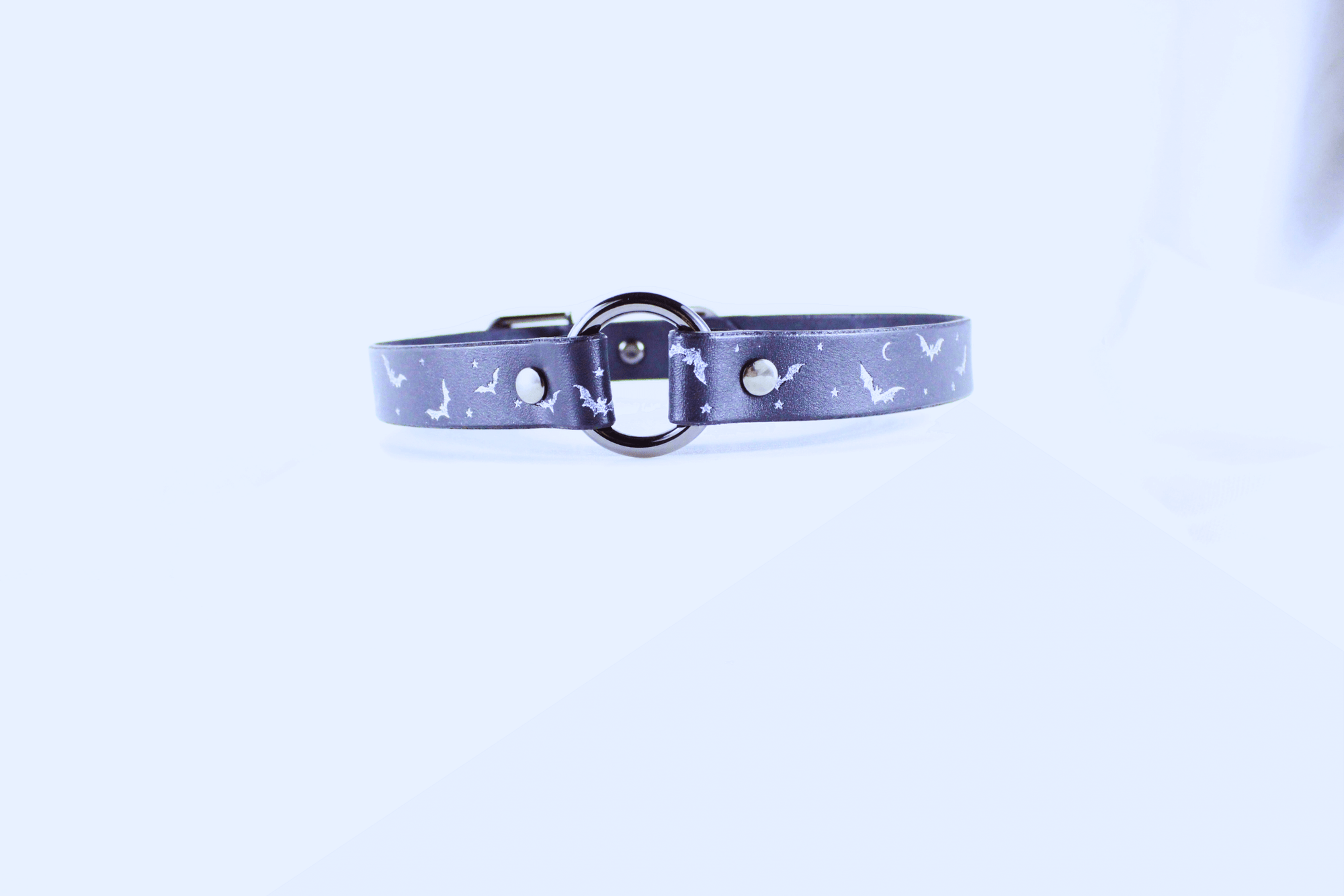 Bat and Moon Leather Choker showcasing bats and crescent moons on a dark leather band.