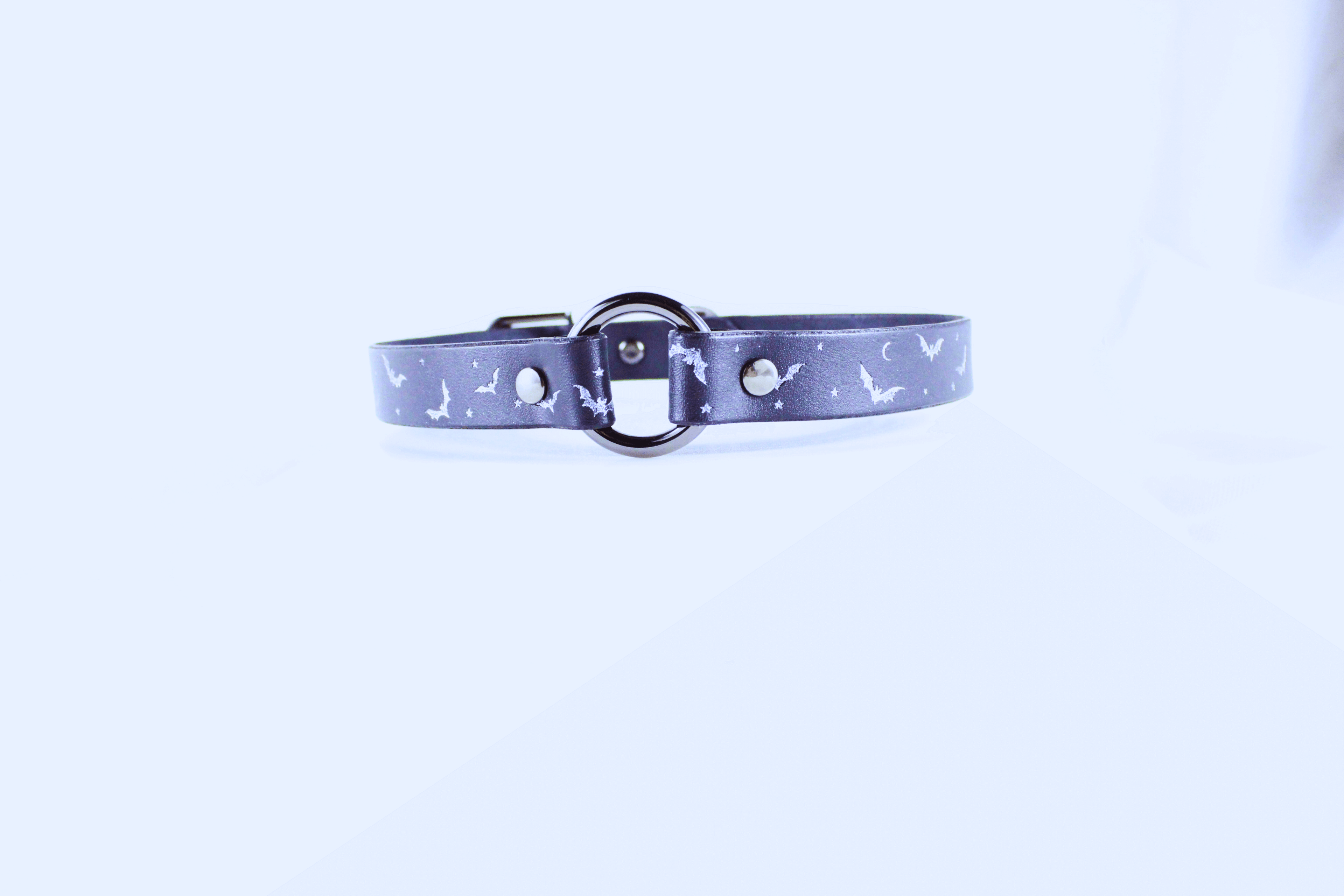 Bat and Moon Leather Choker showcasing bats and crescent moons on a dark leather band.
