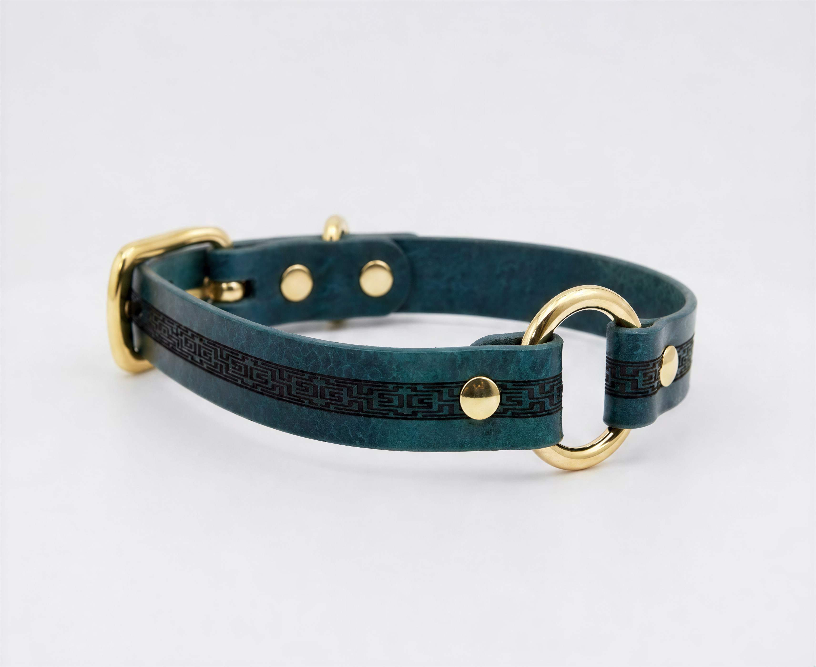 A teal-colored leather dog collar with gold hardware, including a buckle and two rings, is shown against a white background.