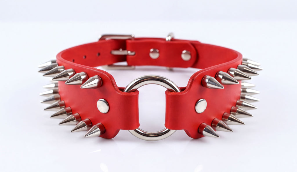 A red leather choker necklace with spikes protruding from it.