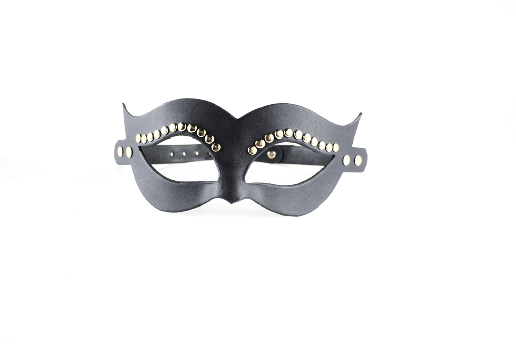 A black leather mask with decorative eye embellishments.