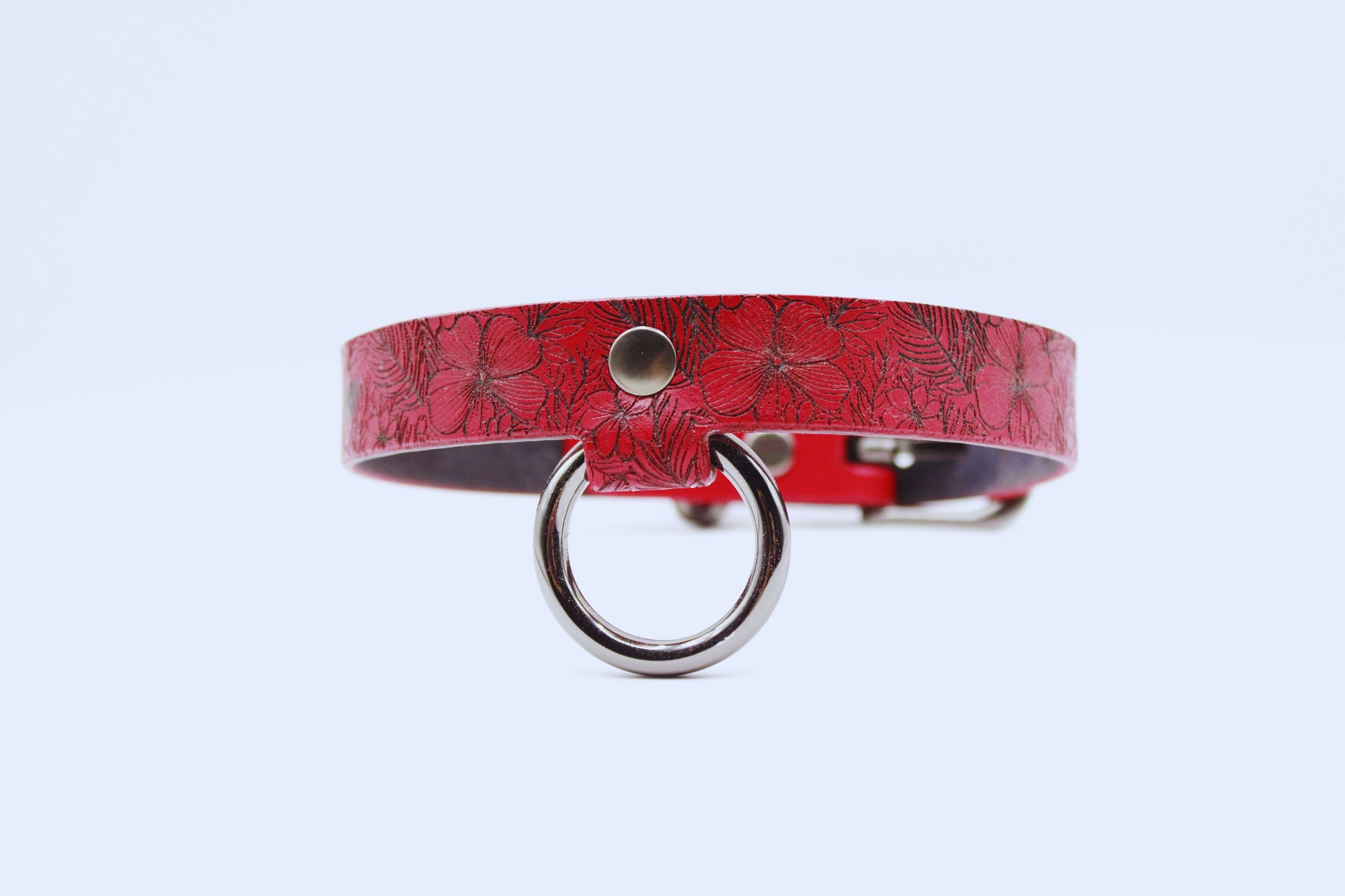Red floral leather choker collar with a silver ring, perfect for a discreet submissive style.