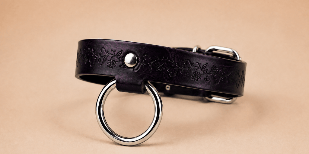 A dark purple leather choker necklace with a metal ring and buckle.