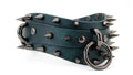 A close-up image of a green leather belt with spikes and metal rings.