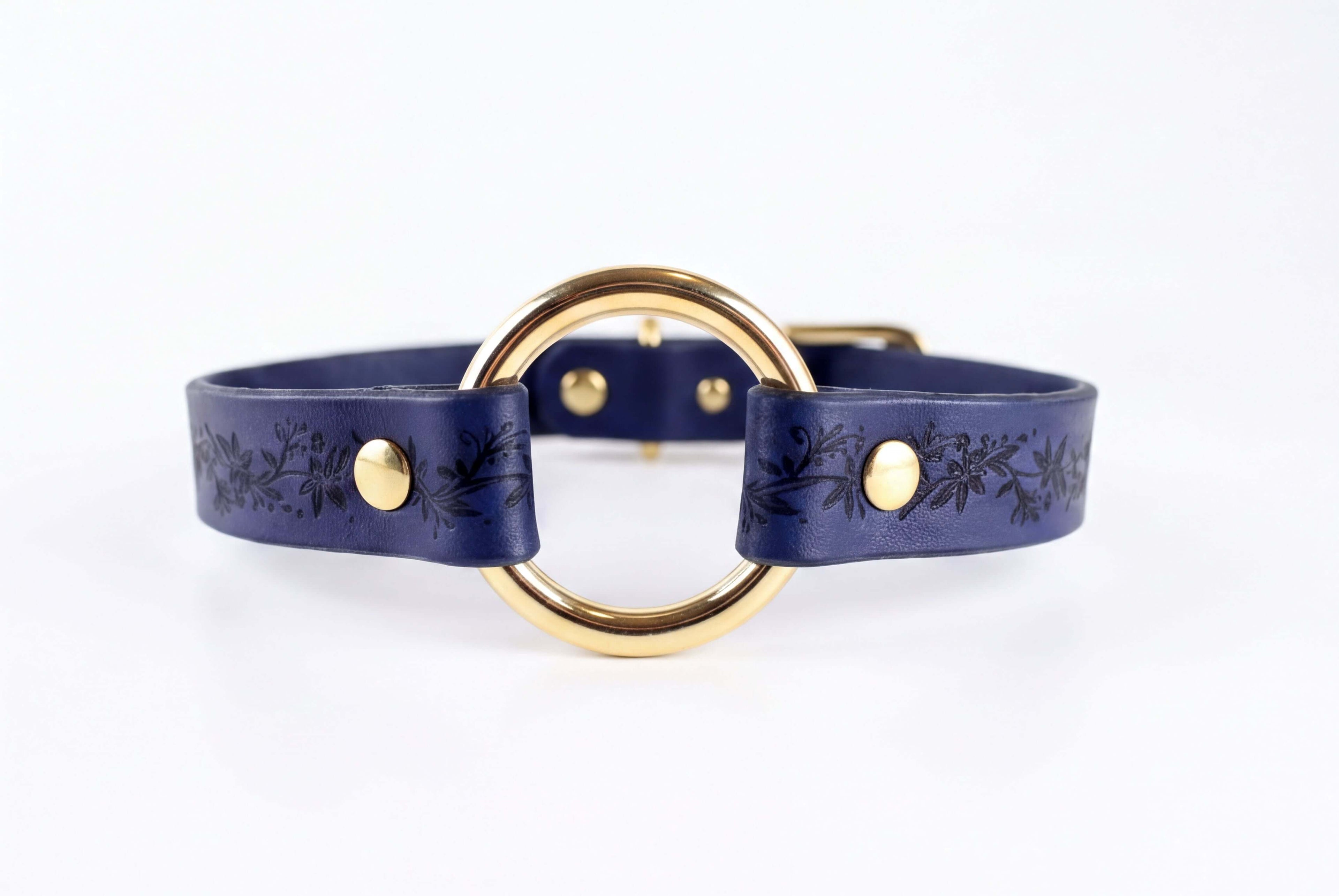 A blue leather choker necklace with a gold-colored circular buckle.