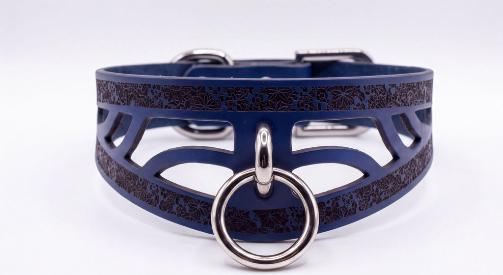 A blue leather choker necklace with a metal ring and a decorative pattern on the front.