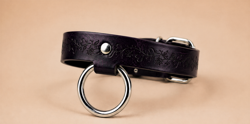 A dark purple leather choker necklace with a metal ring and buckle.