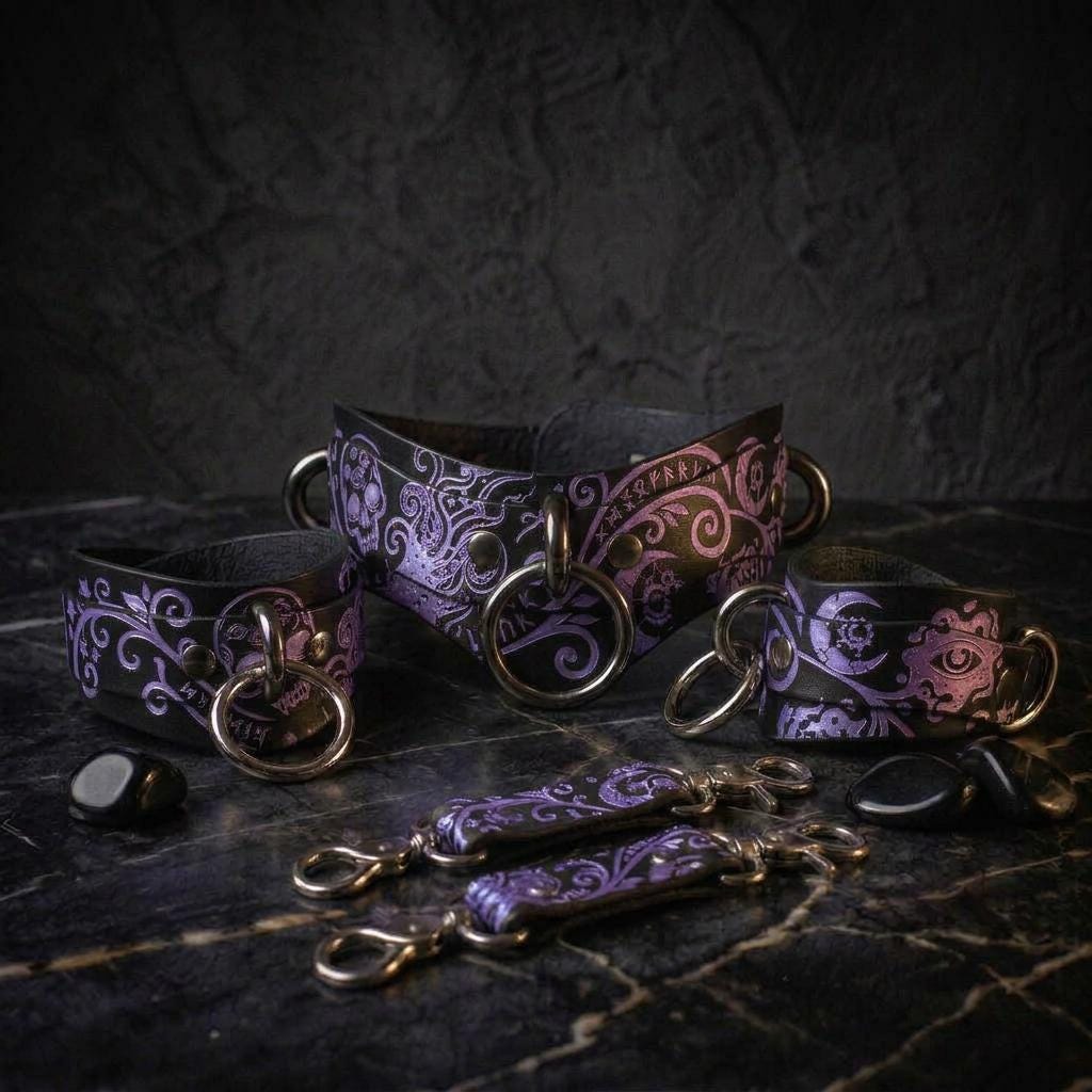 a collection of leather accessories with intricate designs, including rings and straps, arranged on a dark surface.