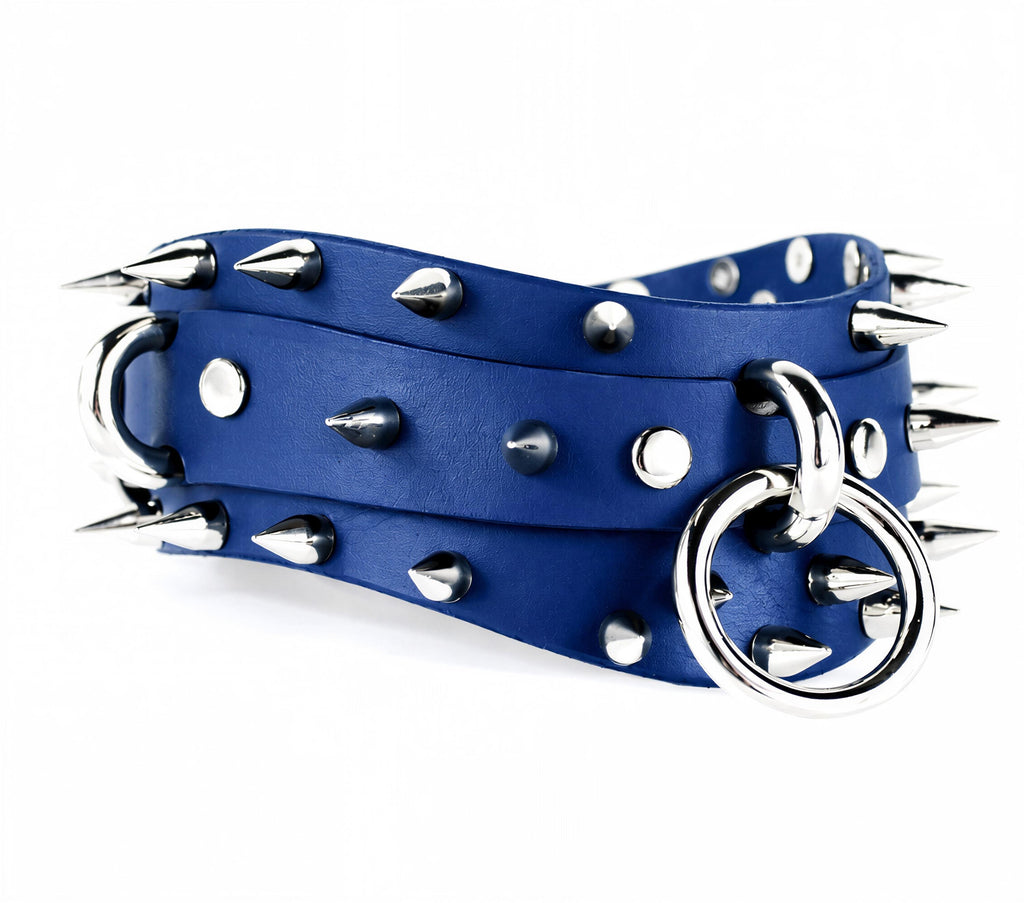 A blue leather belt with silver spikes and a metal ring on it.