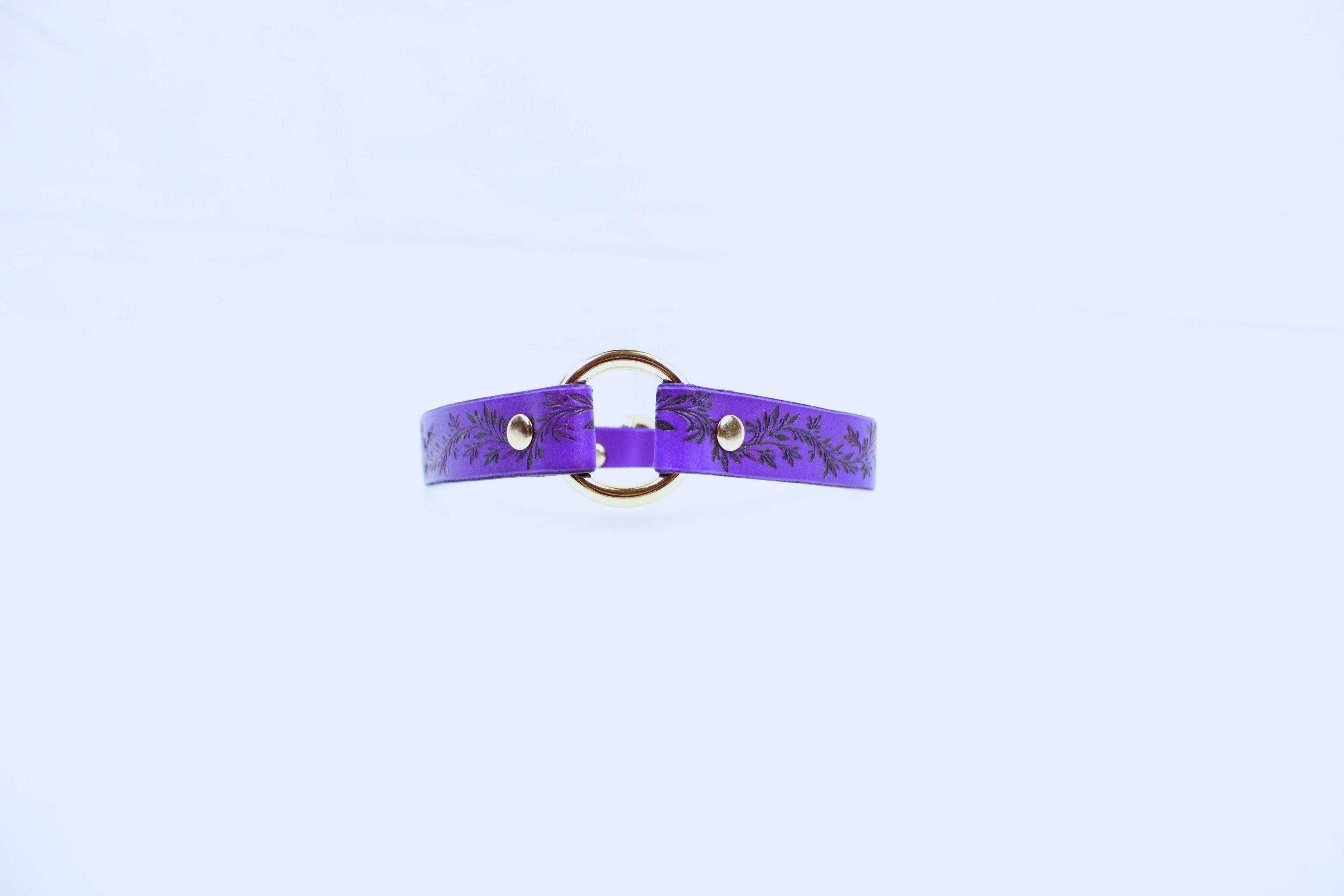 Leaf Pattern Submissive Day Collar in purple leather with gold ring and intricate leaf design.
