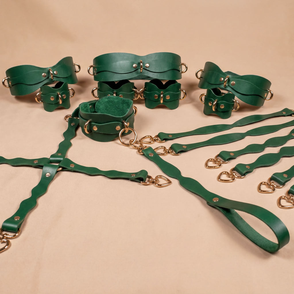 a collection of green leather straps and buckles arranged on a beige background.