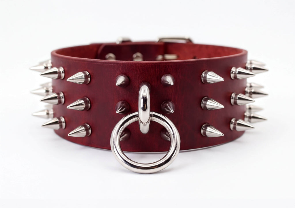 A burgundy leather choker necklace with silver spikes protruding from it.