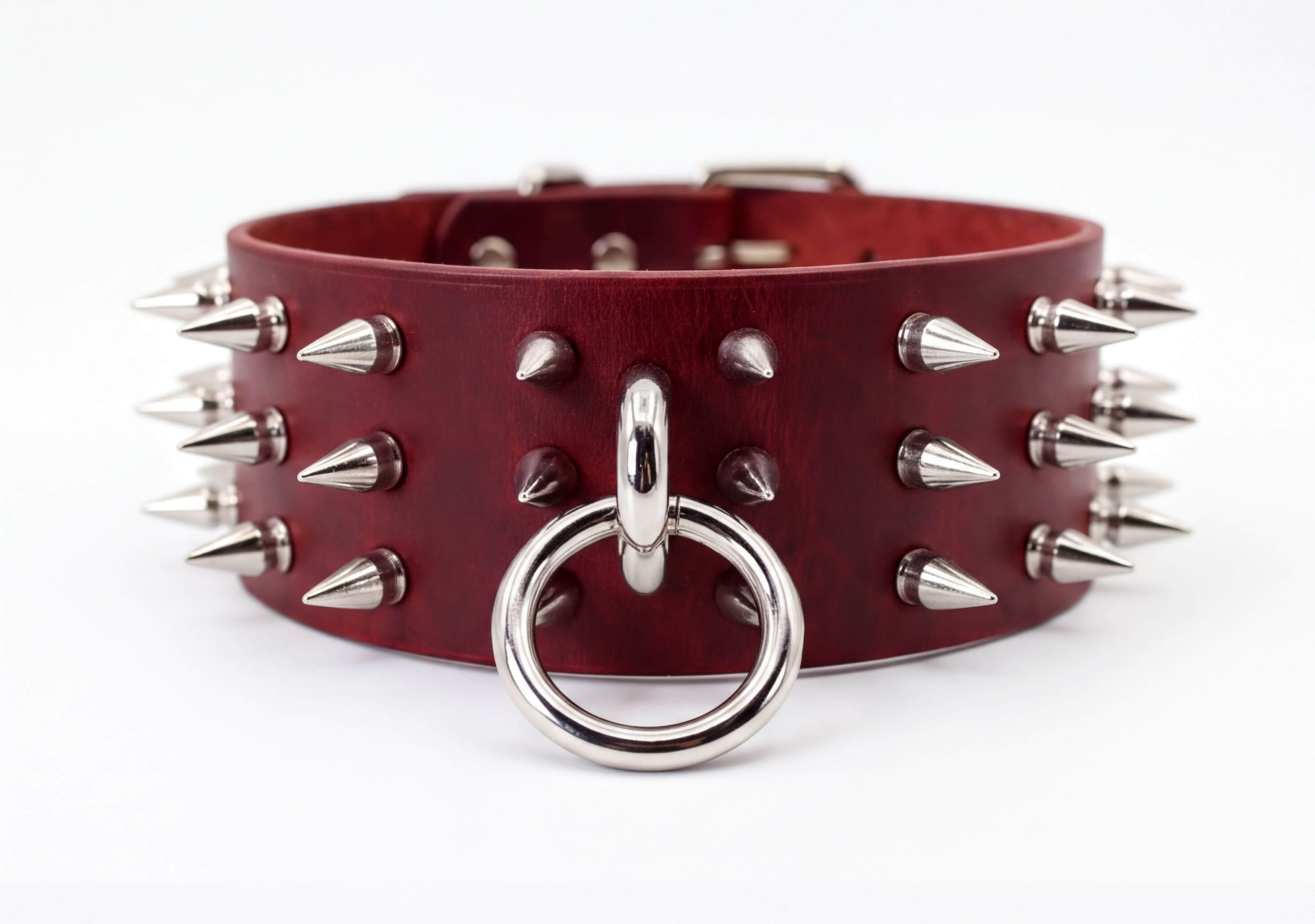 A burgundy leather choker necklace with silver spikes protruding from it.