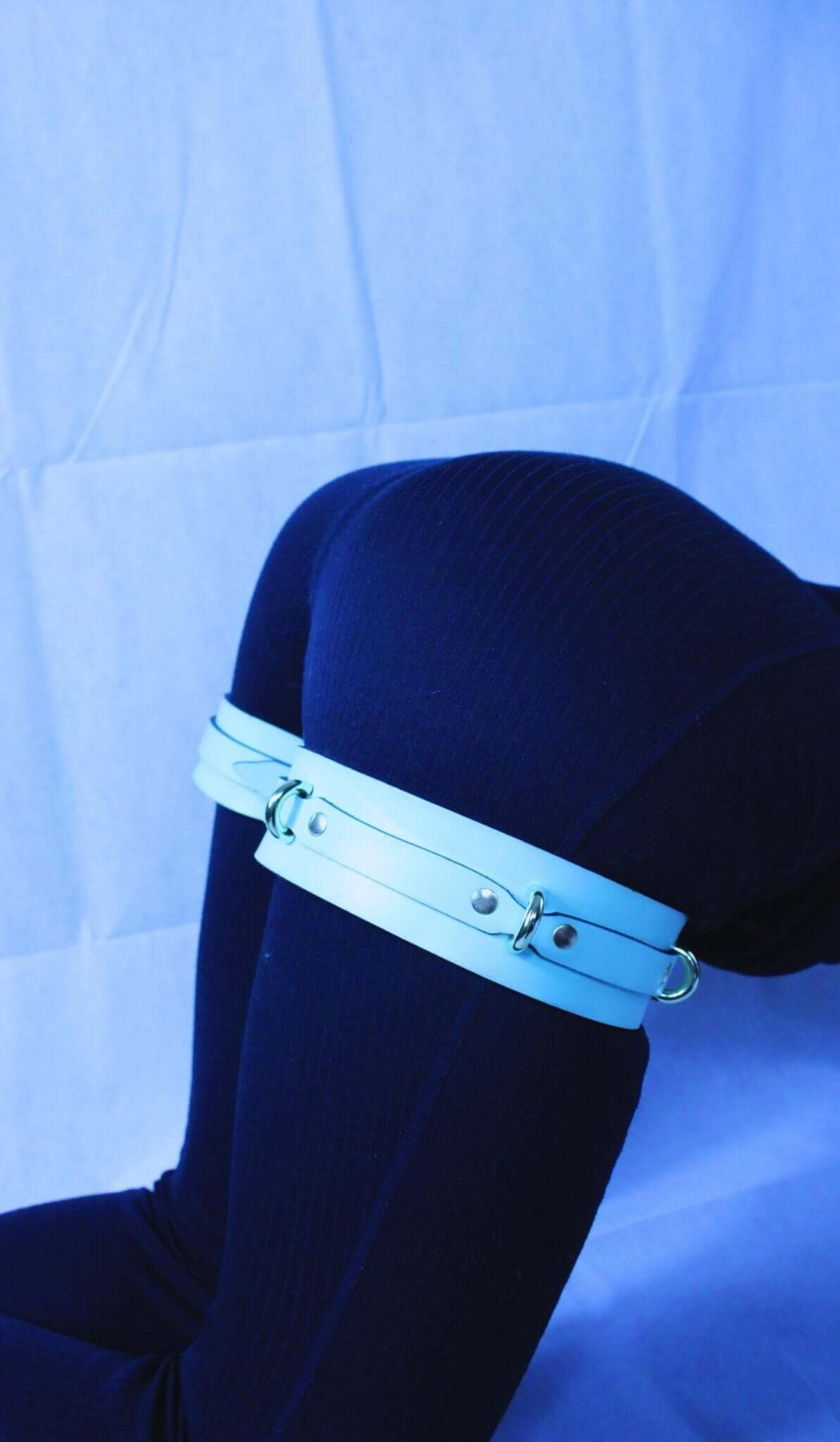Adjustable leather thigh cuffs for bondage play, offering comfort and security for submissive experiences.