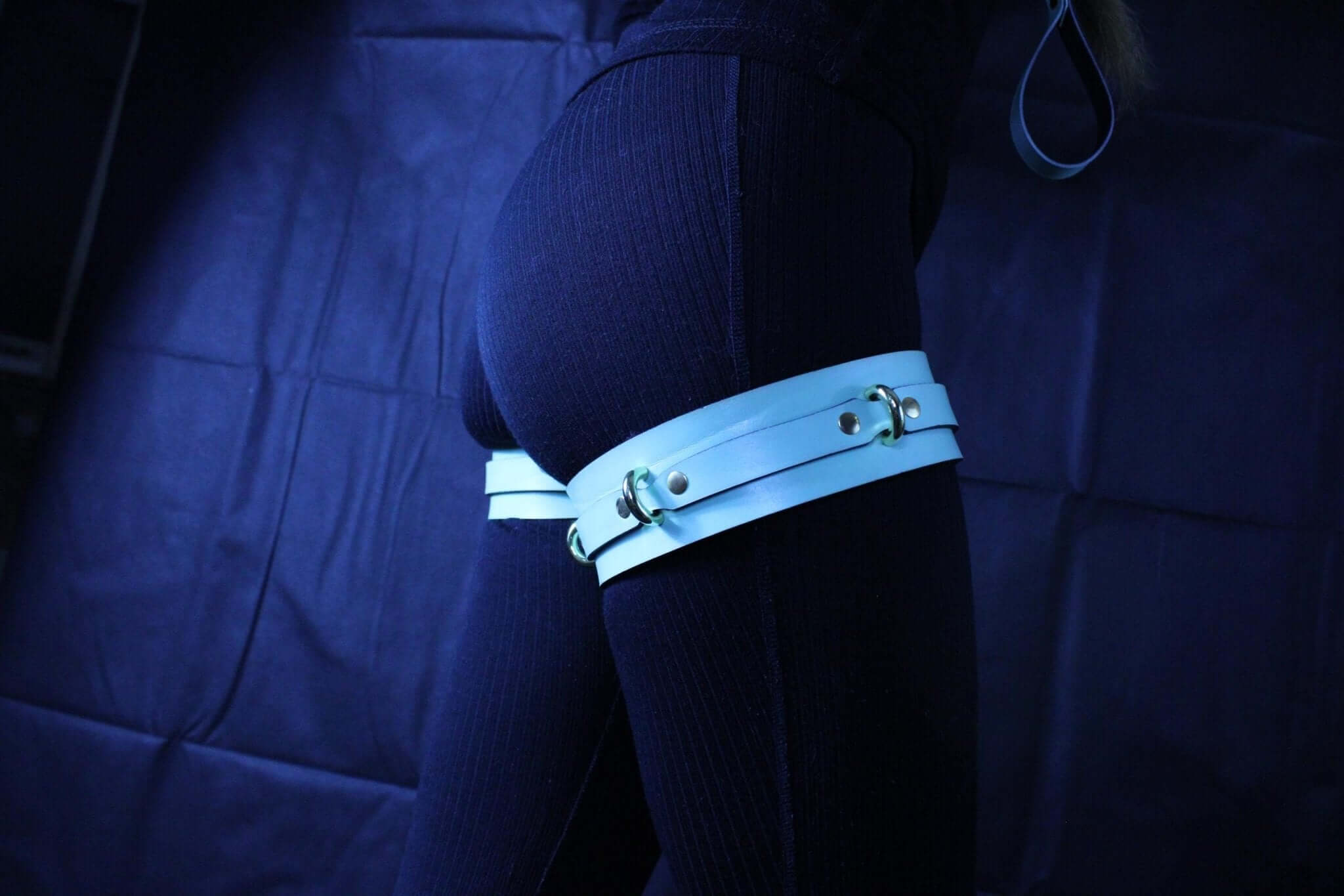 Adjustable leather thigh cuffs for bondage, perfect for restraint play and submissive positioning in BDSM.
