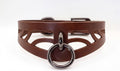A brown leather choker necklace with a metal ring and a metal buckle.