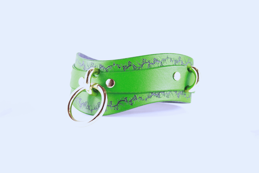 Skull Leather Choker featuring a floral skull motif on vibrant green leather with gold hardware.