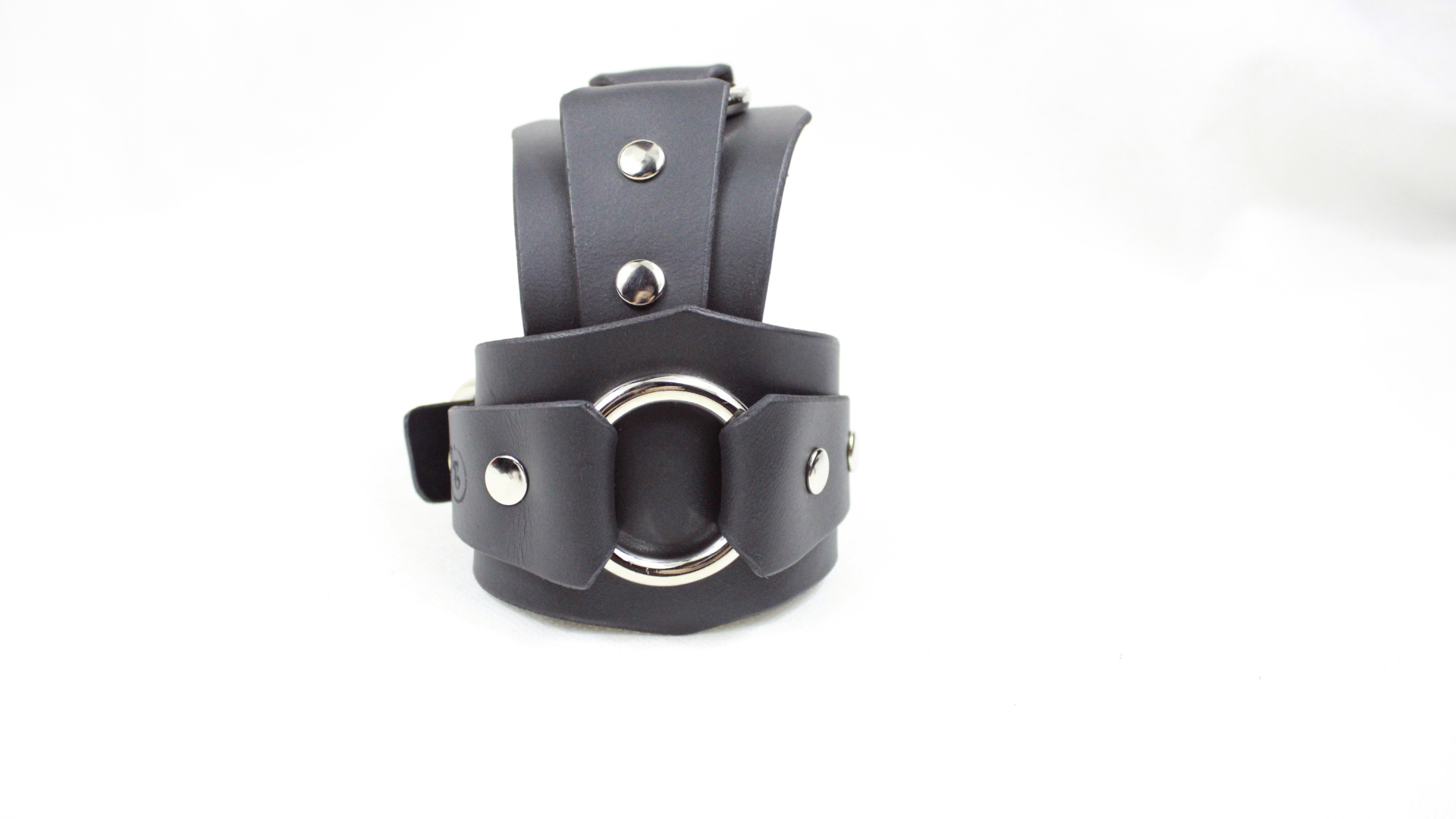 A black leather strap with metal studs and a circular metal buckle.