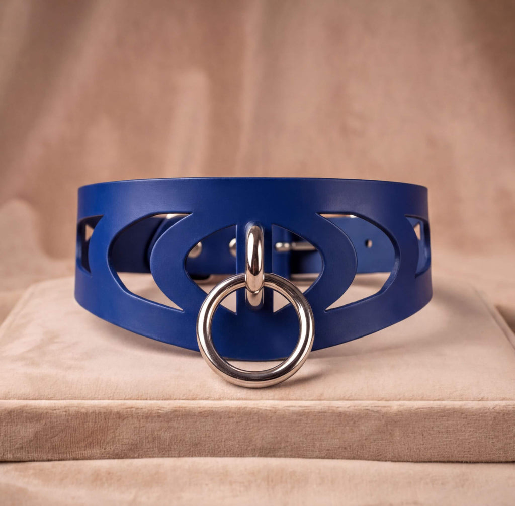 A blue leather choker necklace with a silver ring and a circular cutout design on the front.