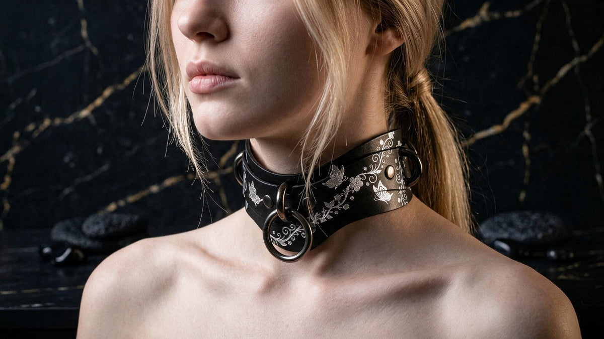 A close-up of a woman's face wearing a black choker necklace with a floral design.