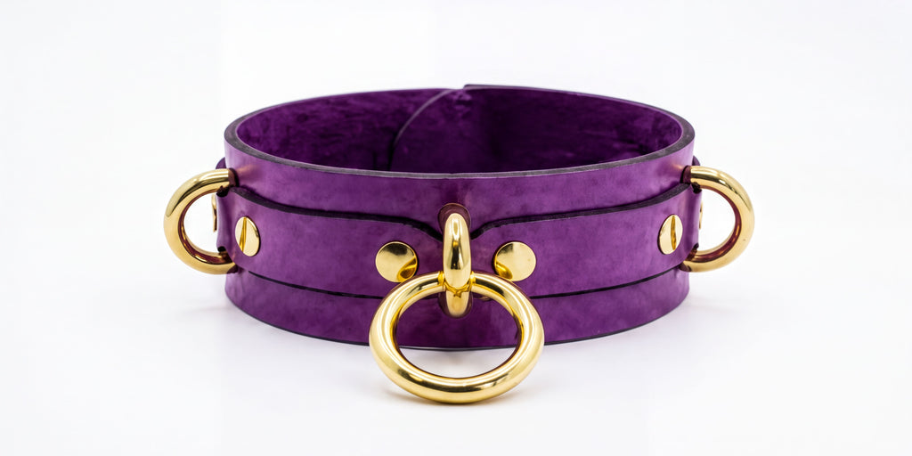 A purple leather choker necklace with gold metal rings and buckles.