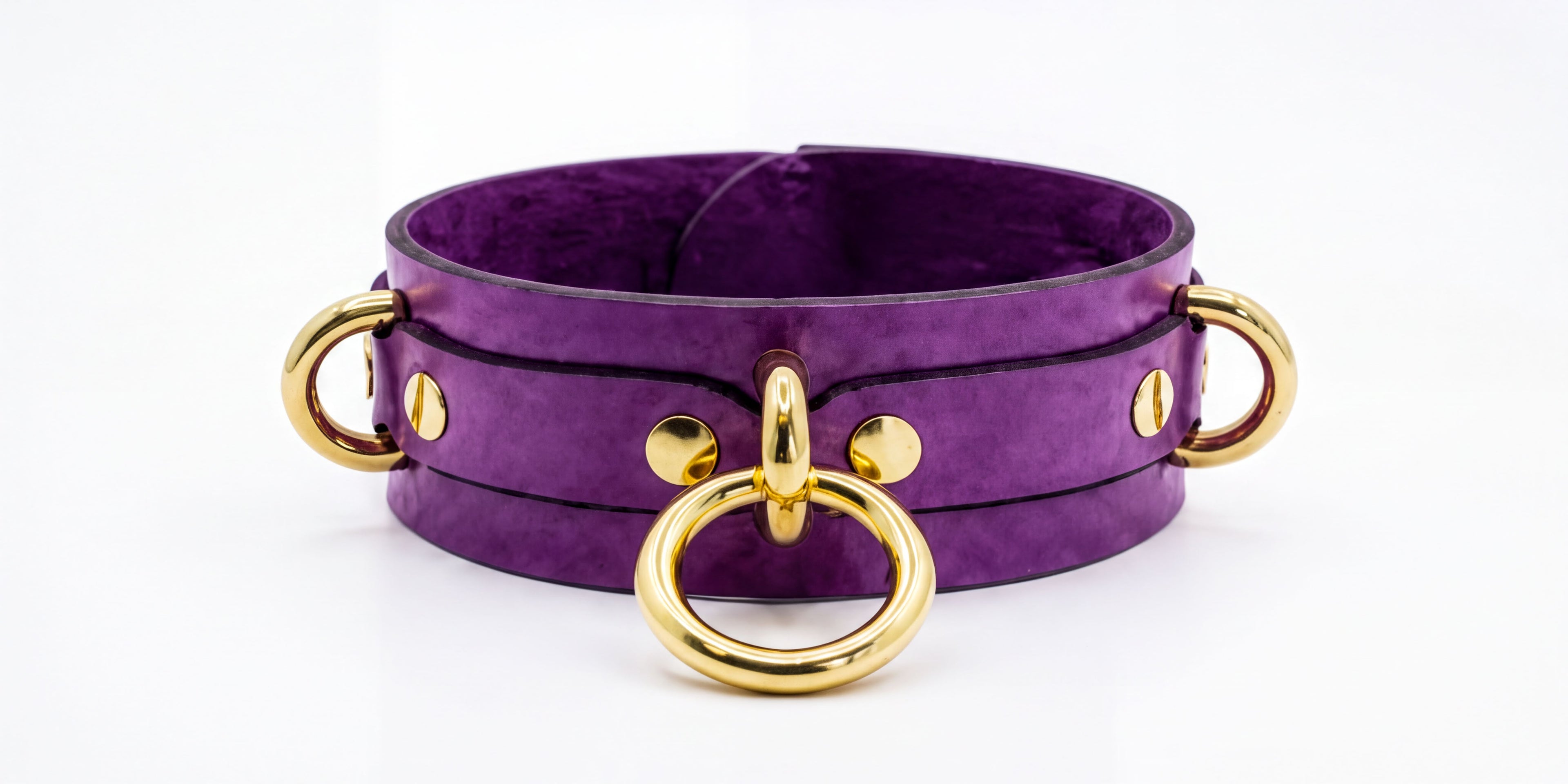 A purple leather choker necklace with gold metal rings and buckles.