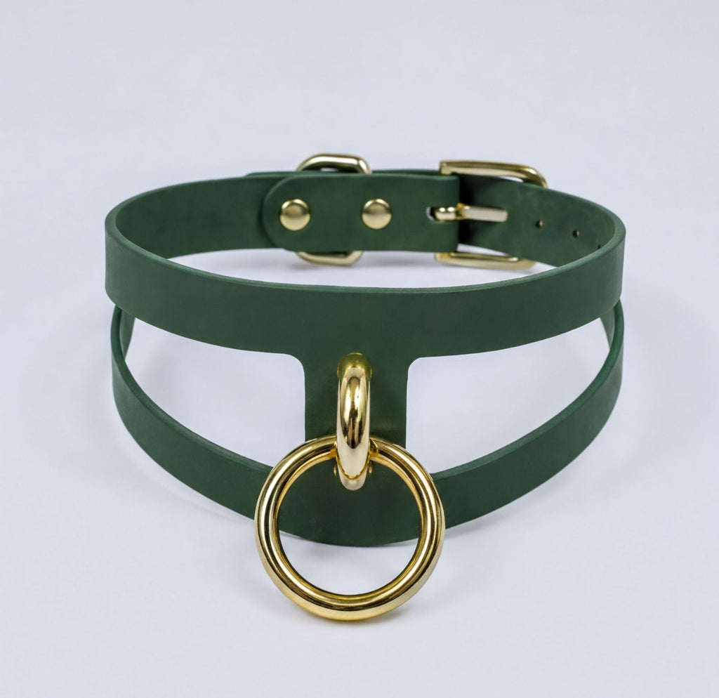 A green leather choker necklace with a gold-colored metal ring attached to it.