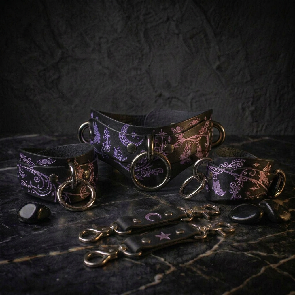 a collection of leather accessories, including a corset, leather straps, and charms, all adorned with intricate floral designs in shades of purple and black.