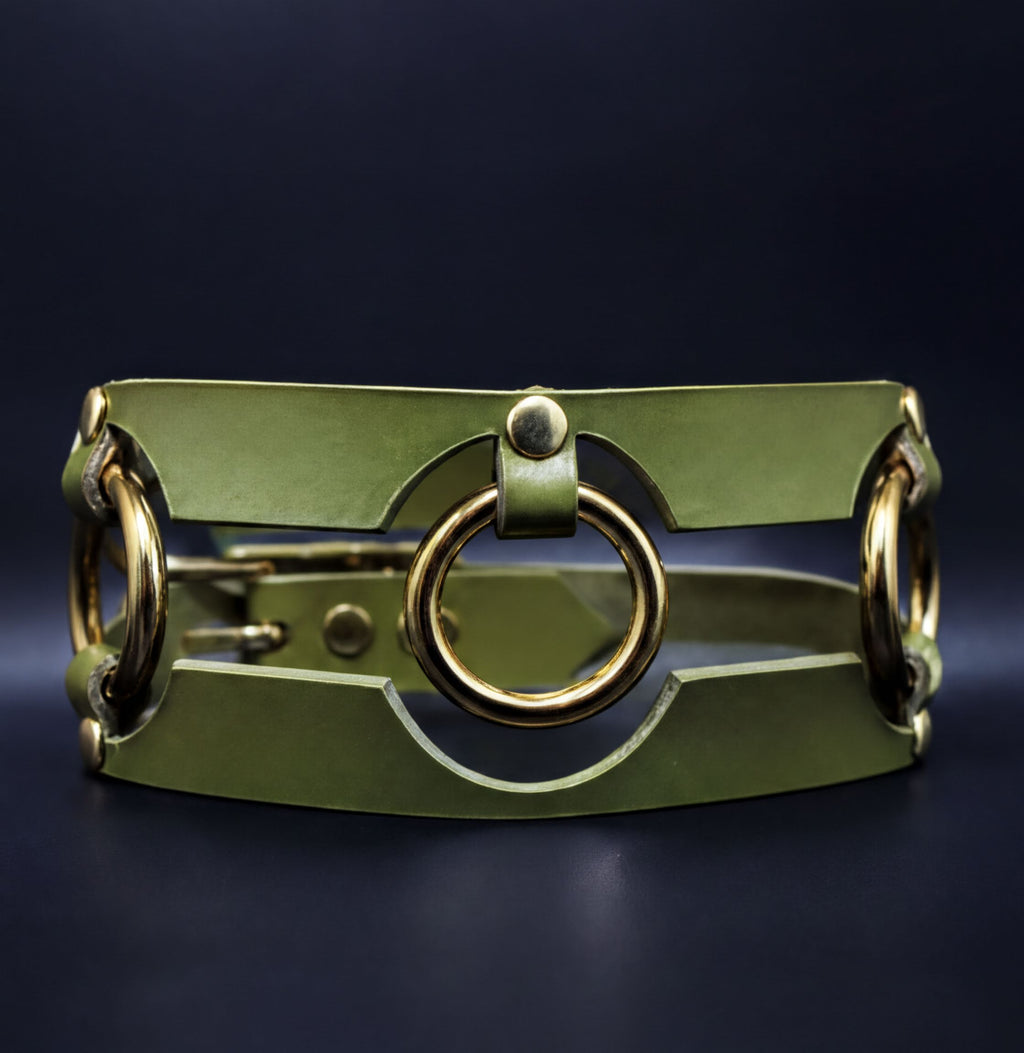 A green leather choker necklace with a unique circular clasp design.