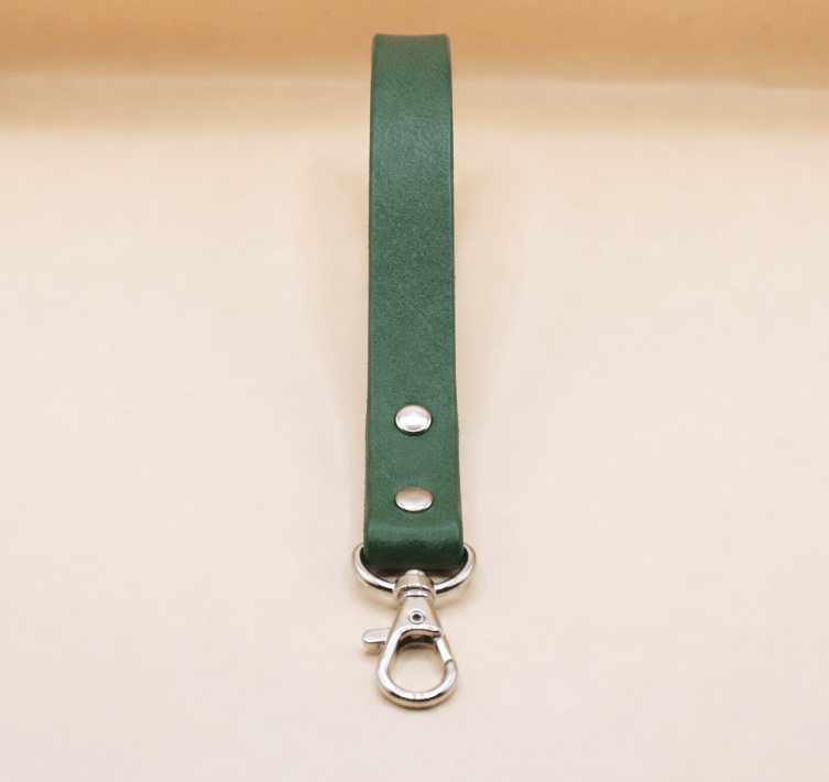A green leather strap with a metal clasp and hook attached to it.