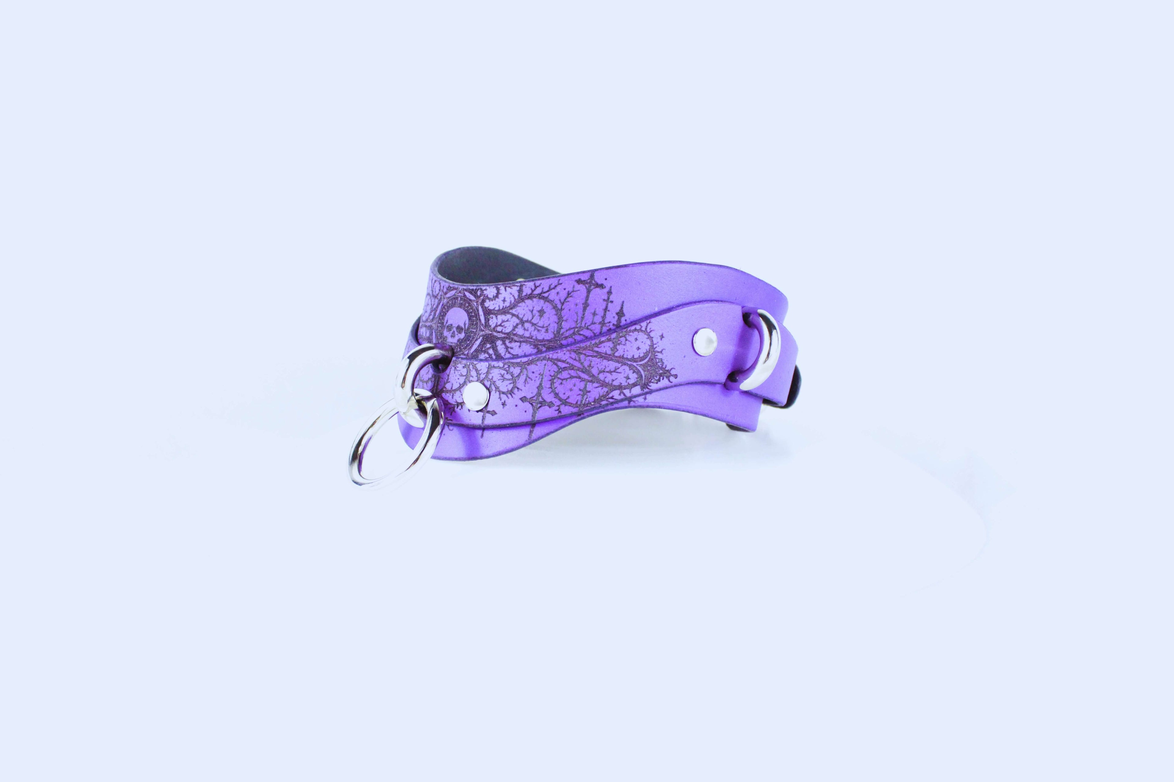 Gothic Skull BDSM Collar – purple leather choker with O-ring, showcasing gothic artistry for intensity and devotion.