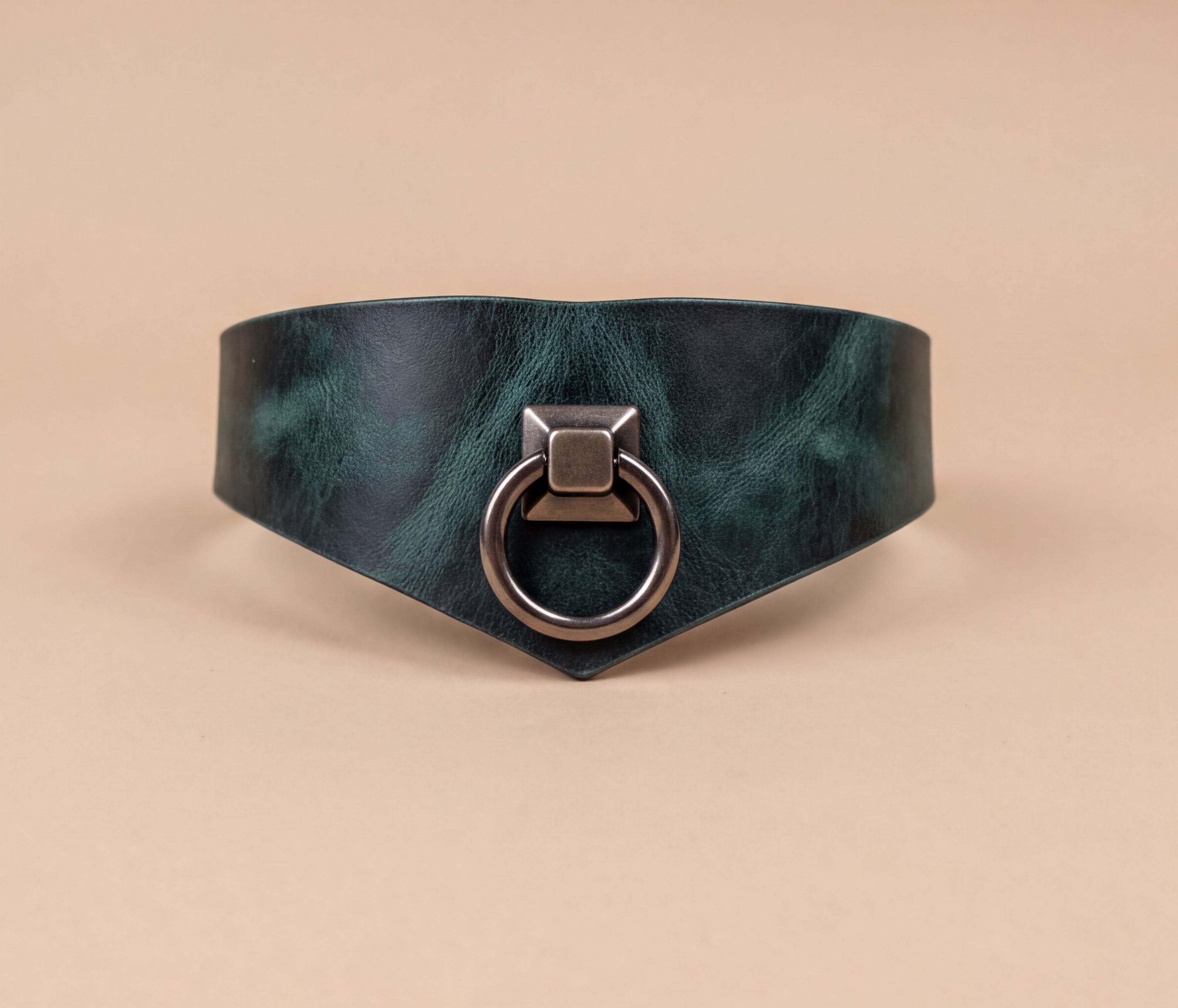 A dark green leather choker necklace with a metal ring and a square-shaped metal piece on the front.