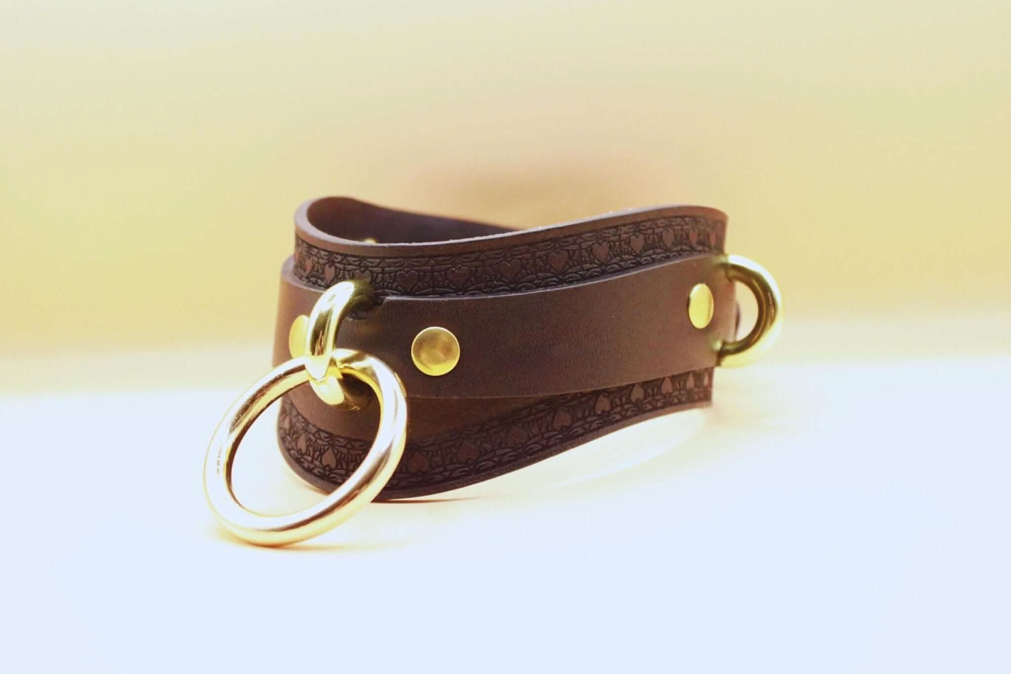 Discreet black leather BDSM collar with gold accents for submissive jewelry and bondage gear.