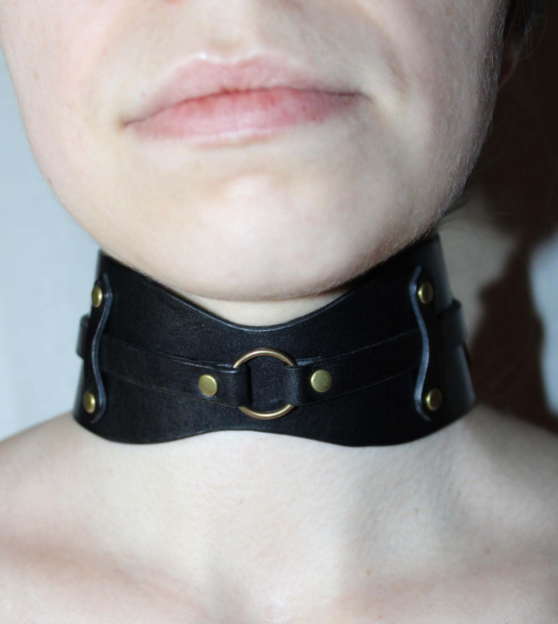Edgy leather submissive collar choker with O-ring for BDSM fashion and kink scenes.