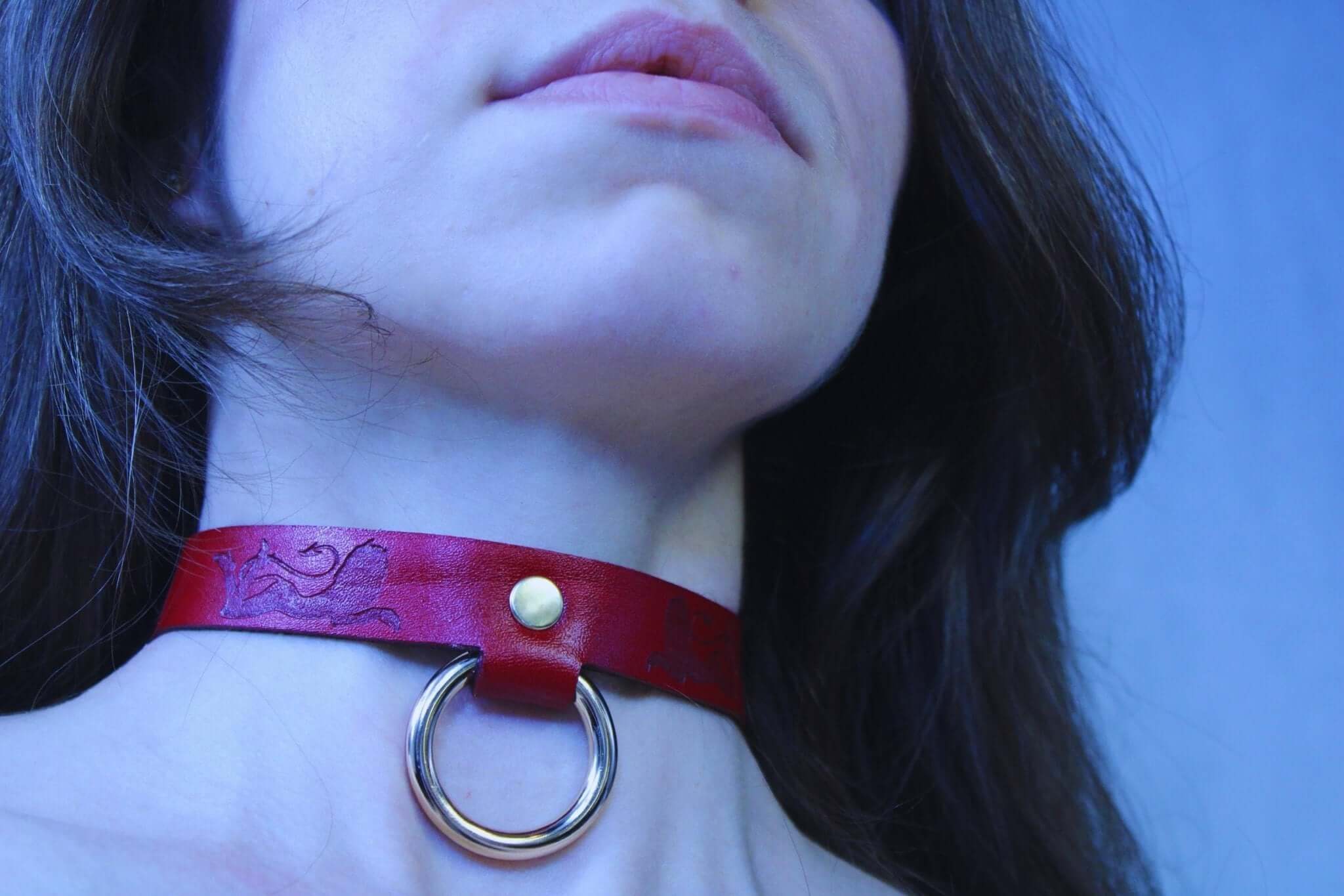 BDSM collar with devil girl design, red leather choker, ideal for submissive jewelry and bondage gear.
