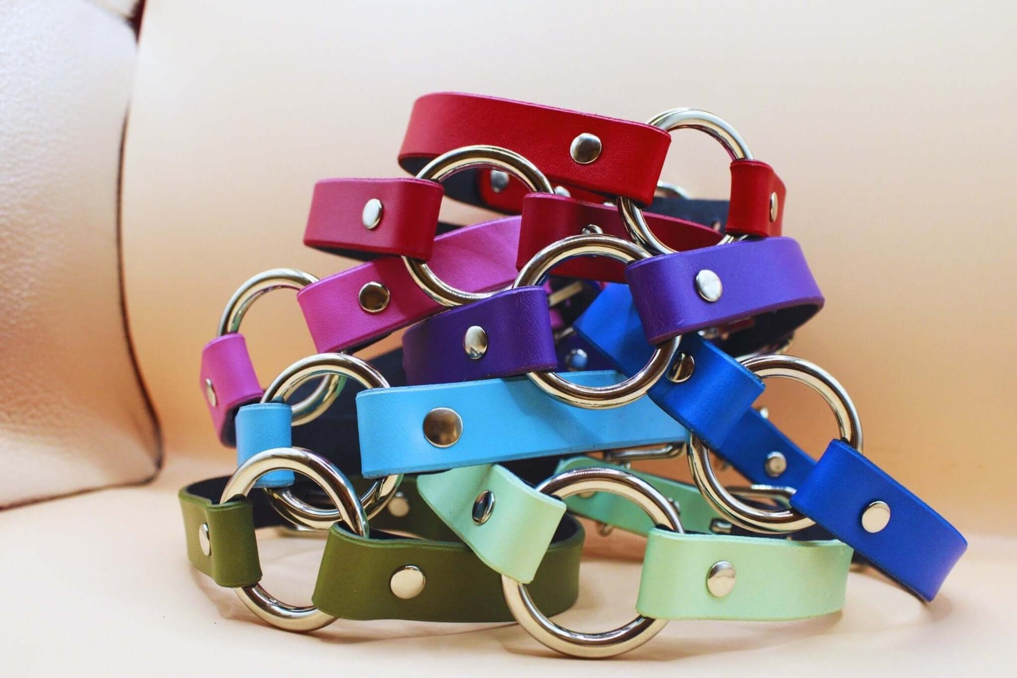 Colorful leather collars stacked together, perfect for BDSM day collar, submissive jewelry, and bondage gear.