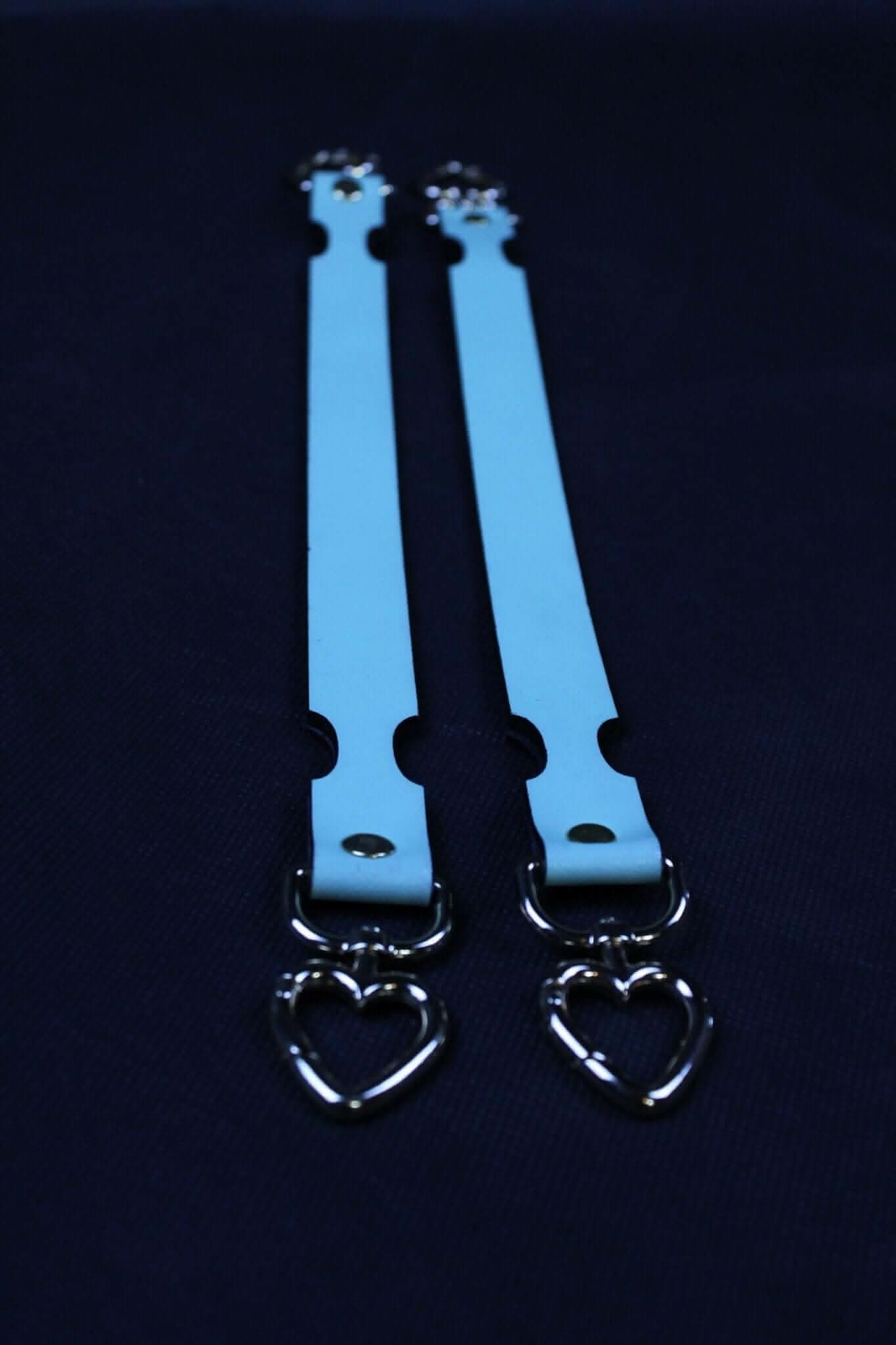 Blue leather connector straps with heart-shaped metal clasps, ideal for BDSM and bondage play accessories.