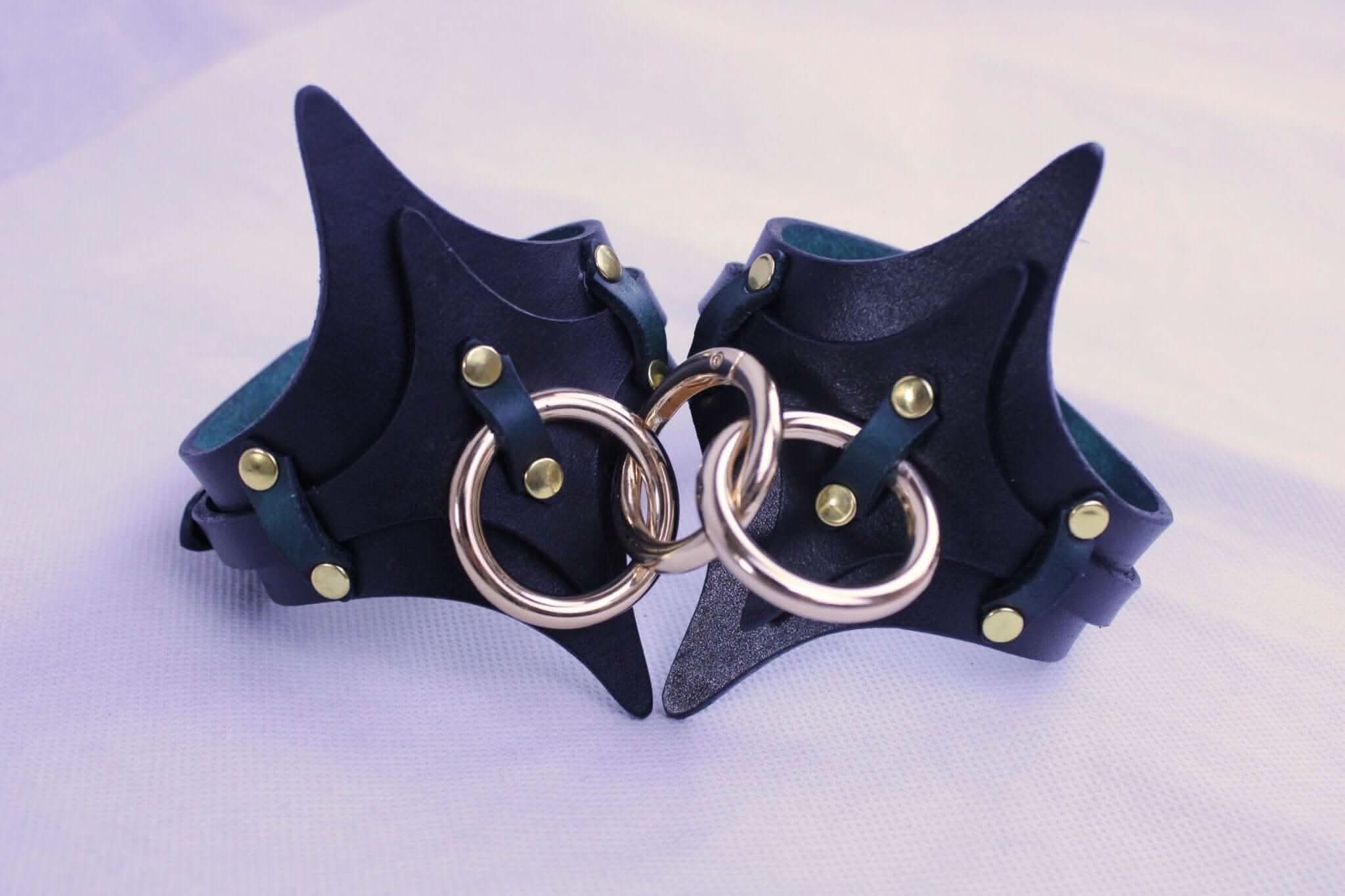 Handmade BDSM leather handcuffs with brass hardware for stylish restraint and pleasure in bondage. Ideal for submissive play.