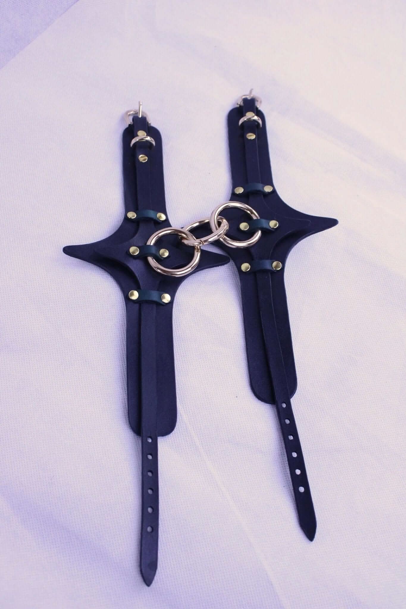 Handmade leather BDSM handcuffs with solid brass hardware, ideal for bondage gear and submissive play.