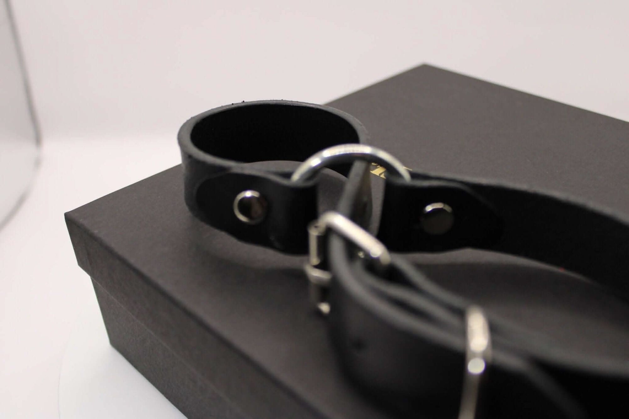 Close-up of leather handcuffs, ideal for BDSM play, bondage gear, and enhancing intimate experiences.